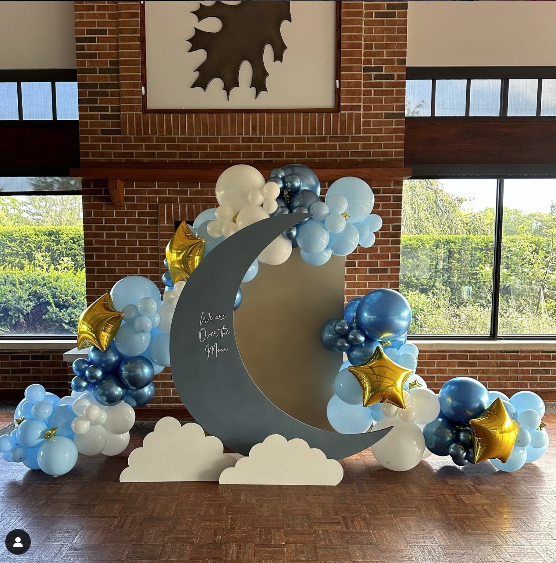 Moon themed event decoration with blue and gold balloons